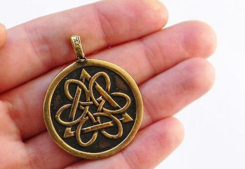 Coin amulet of luck out of poverty in hand