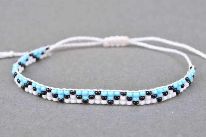 A bracelet made of threads and beads is a talisman that brings good luck to the owner
